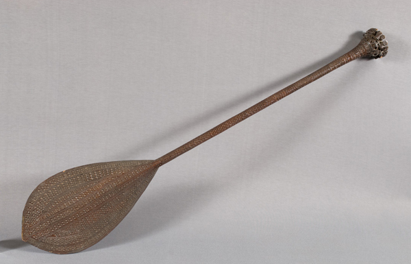 A carved wooden ceremonial Polynesian paddle.