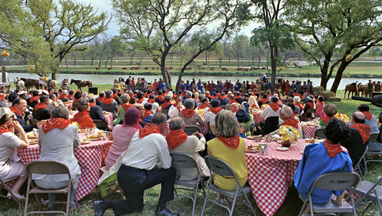 Guests attired in red bandanas enjoy entertainment during the 1967 barbecue on the LBJ Ranch