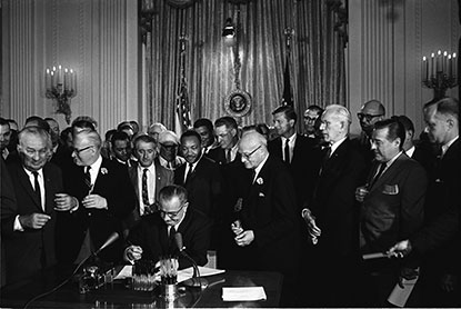 Lyndon Johnson signing the Civil Rights Act of 1964 into law.