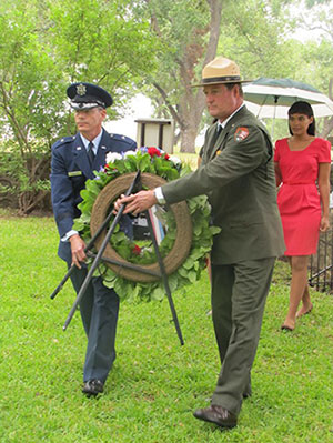 A military representative and park superintendent Russ Whitlock place a wreath at the president's grave.