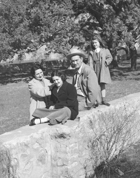 The Johnsons sit on the rock wall surrounding the family cemetery on the LBJ Ranch