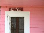 sign over door of pink Sirois House