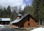 Cedar-shingled metal-roofed building.