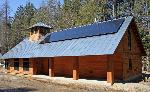Cedar-shingled metal-roofed building.