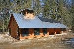 Cedar-shingled metal-roofed building.