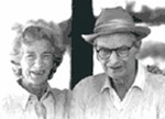 Black and white portrait of Mary and Laurance Rockefeller, she on the left, he in a hat and black-rimmed glasses.