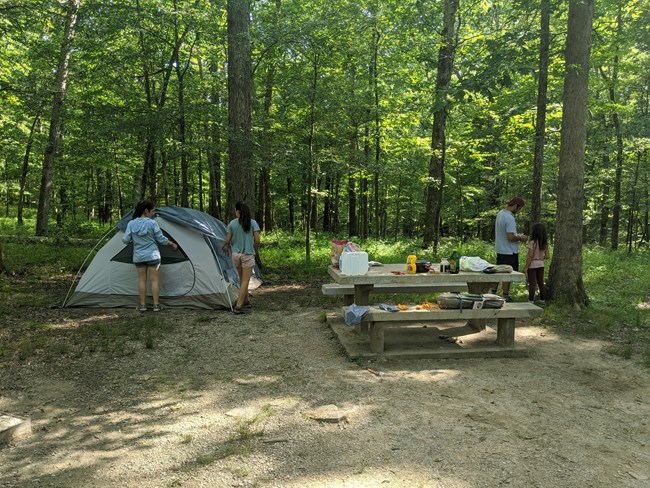 Family setting up campsite