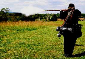 Park ranger John Reid performing a musket demonstration