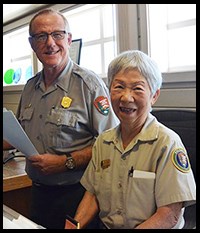 Volunteer and Park Ranger at visitor center desk