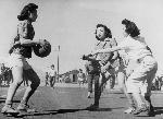 Girls playing basketball outdoors