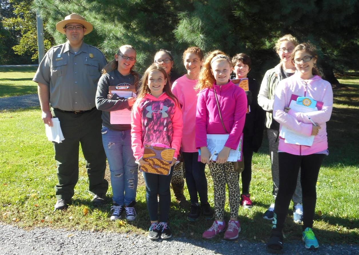 Students and a park ranger smiling for the camera on a field trip