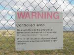 Security sign on fence at Delta-01