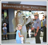 Freddie the Flathead Catfish and a park ranger at the Mississippi Visitor Center with guests.