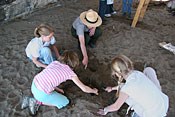 An NPS Ranger helps direct students in an archeaological dig.