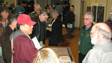 Participants gather around a table at the Open House.