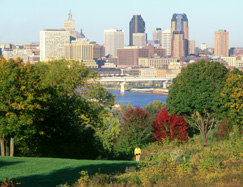 A city skyline looms over the Mississippi River.