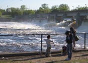 Water spills over the watergates of a dam on the Mississippi River.