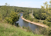 Historic Fort Snelling nestled in the forest with the Saint Paul city skyline in background.