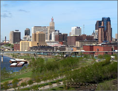 A city skyline looms over the Mississippi River.