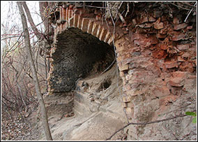 The remains of an old brick kiln, used to fire bricks, produced in this area, sits in a wooded area.