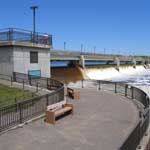 Coon Rapids Dam and the Mississippi River under bright sunshine and blue sky.