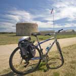 A bicycle sits in front of the stone round tour at Historic Fort Snelling.
