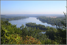 The island-dotted Mississippi River flows past forested banks and into the distance.