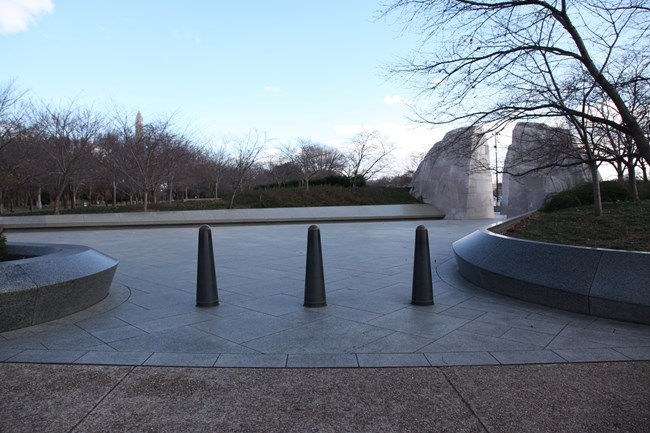 Three bollards are embedded in the sidewalk leading to the Martin Luther King, Jr. Memorial