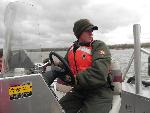 Park Ranger Brian Korman maneuvers boat