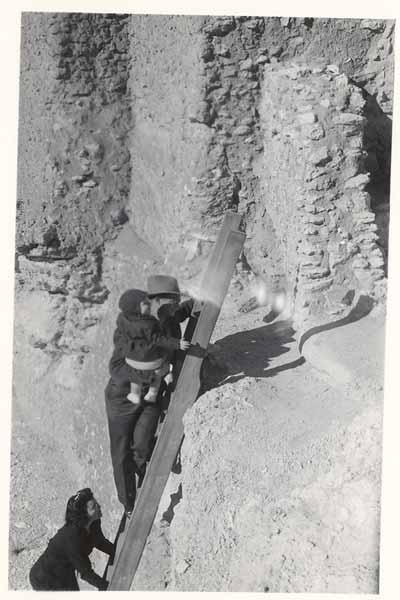1946 picture of visitor climbing ladder to Castle