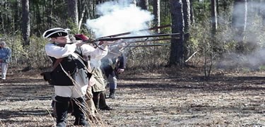 Line of soldiers firing muskets.
