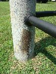 PA 4) Fence post with biological growth and rust