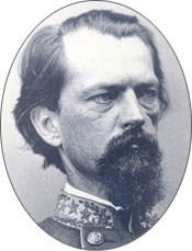 Head of a middle-aged man with a goatee and mustache. The collar of a Confederate uniform is visible with stars on the collar.
