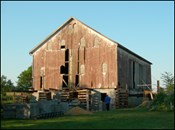 Bank barn with missing siding.