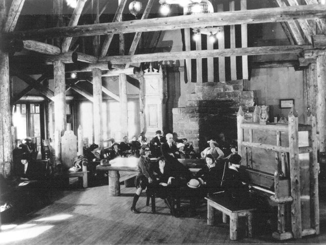 People seated near piano and fireplace in Paradise Inn in the 1920s.