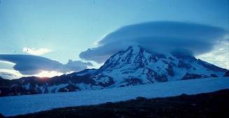 Sunrise filtering though the lenticular clouds on Mount Rainier.