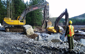 Heavy equipment repairing the Nisqually Road washout.
