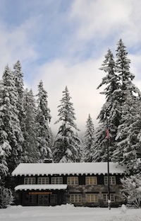 The historic Longmire Administrative Building with a light coating of fresh snow.