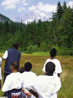 Kids at Longmire Meadow with Mount Rainier in the background.