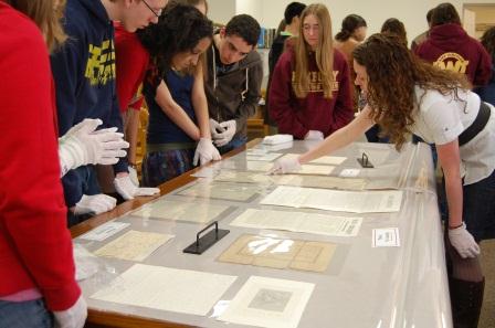 NPS staff instruct students how to utilize documents form the museum collection.  