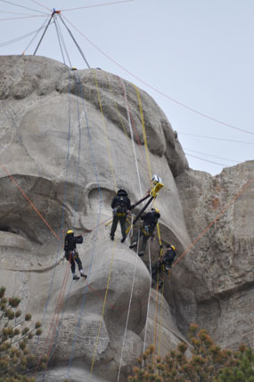 Mount Rushmore's ropes team scans Theodore Roosevelt.