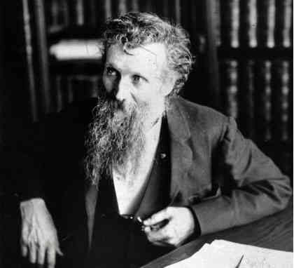 John Muir Sitting at Desk