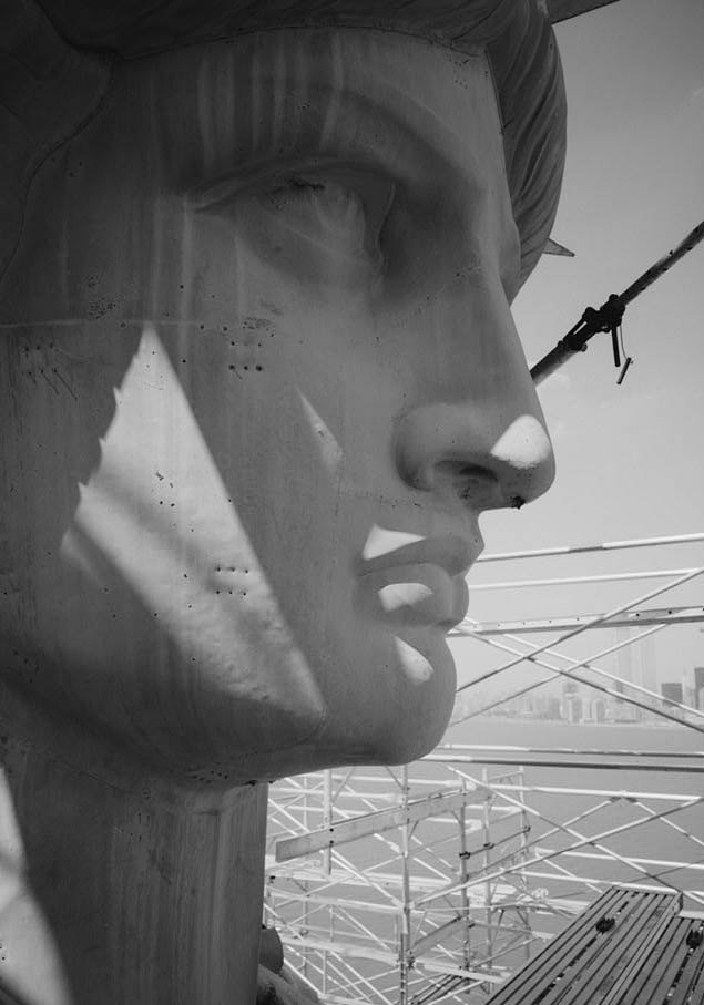 Photograph of Statue of Liberty, profile view of right-side of face 

