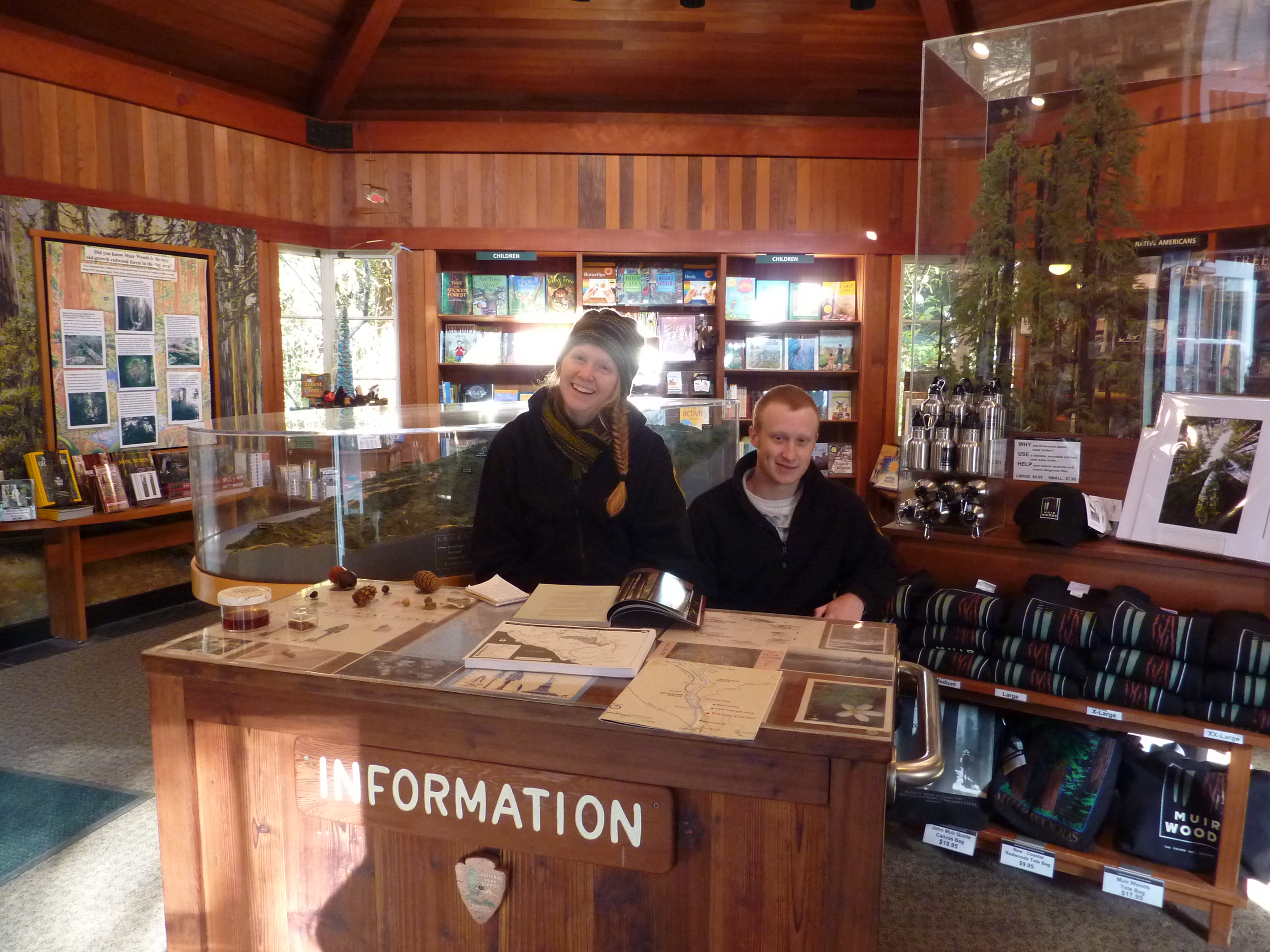 NPS Interpretive Interns Kristen Henderson and Cooper Griffen greet visitors in the Muir Woods Visitor Center.