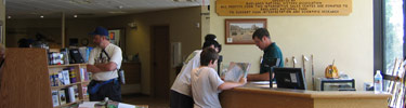 Visitors purchasing items at the Badlands Natural History Association bookstore, Ben Reifel Visitor Center