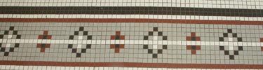 geometric tile pattern of rust, black and white small square tiles