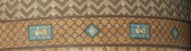 close up of tile on Quapaw dome. There is a zigzag pattern of bluish and grayish tile; bottom border has diagonally oriented dark tan tiles