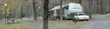 RV parked at volunteer site at Gulpha Gorge Campground, picnic table to left