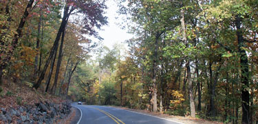 West Mountain scenic road with overhanging trees in red and yellow fall color.
