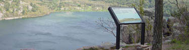 An interpretive panel along the trail looking out over Devil's Lake.